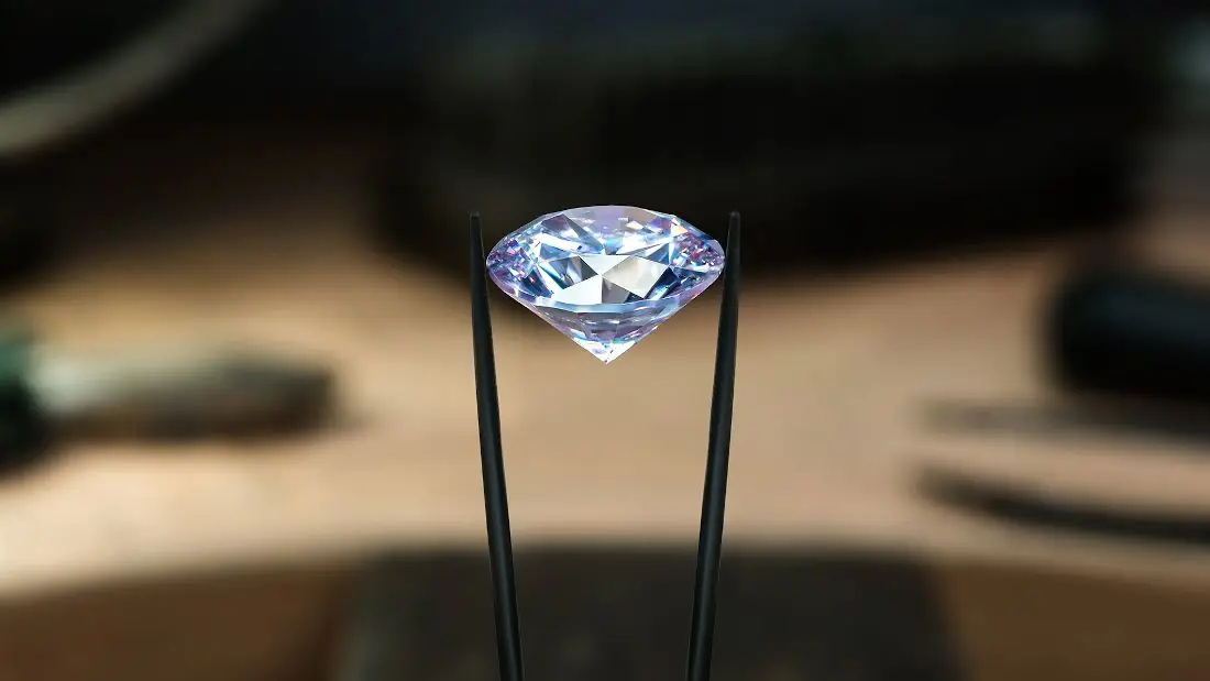 Diamond held by tweezers