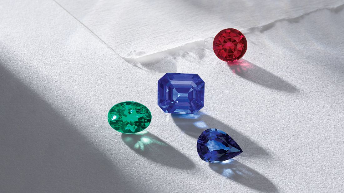 four gemstones of different cuts and colors