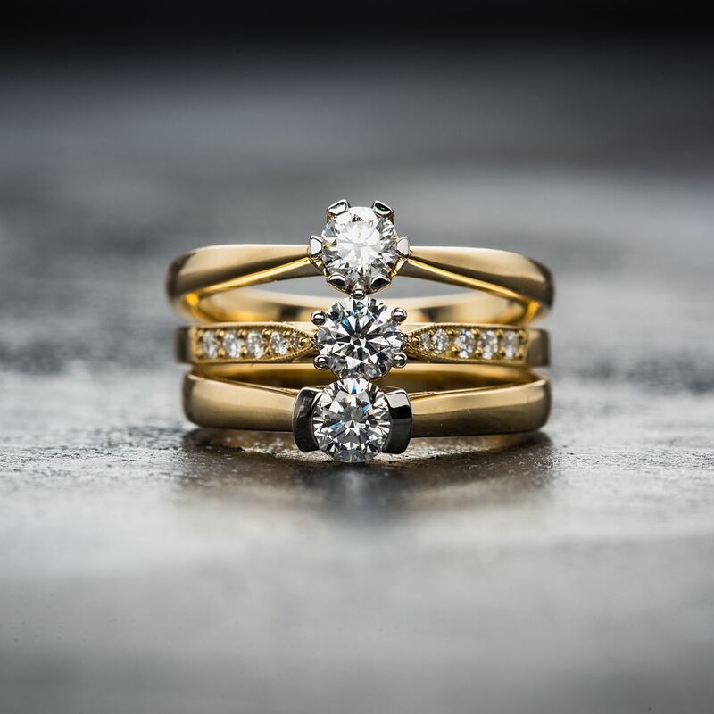 3 diamond rings with gold bands stacked on top of each other