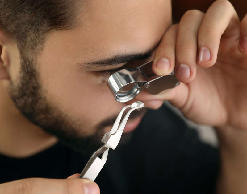 gemologist inspecting a diamond